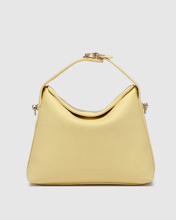 A yellow Louenhide Andie Lemon handbag with a fold-over closure and a trapeze shape design, displayed on a white background.
