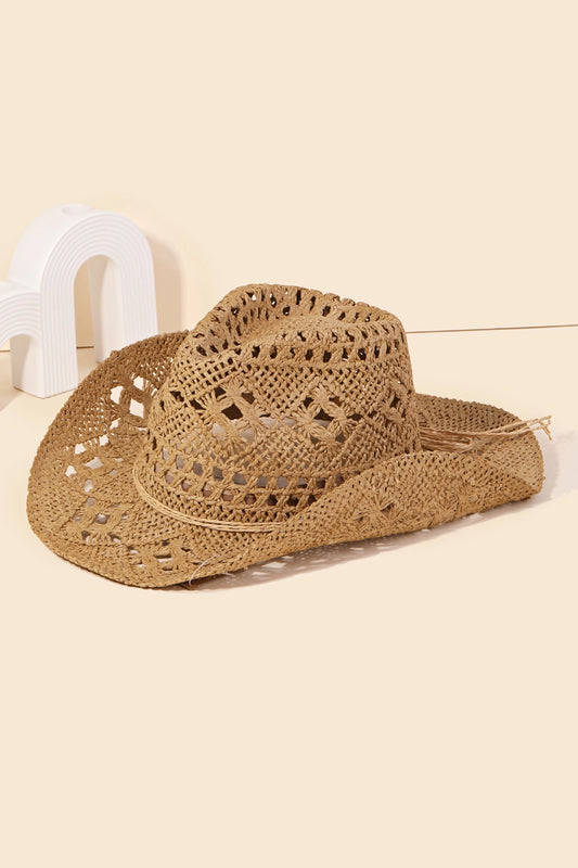 A beige straw cowboy hat with a braided design placed on a white surface.
