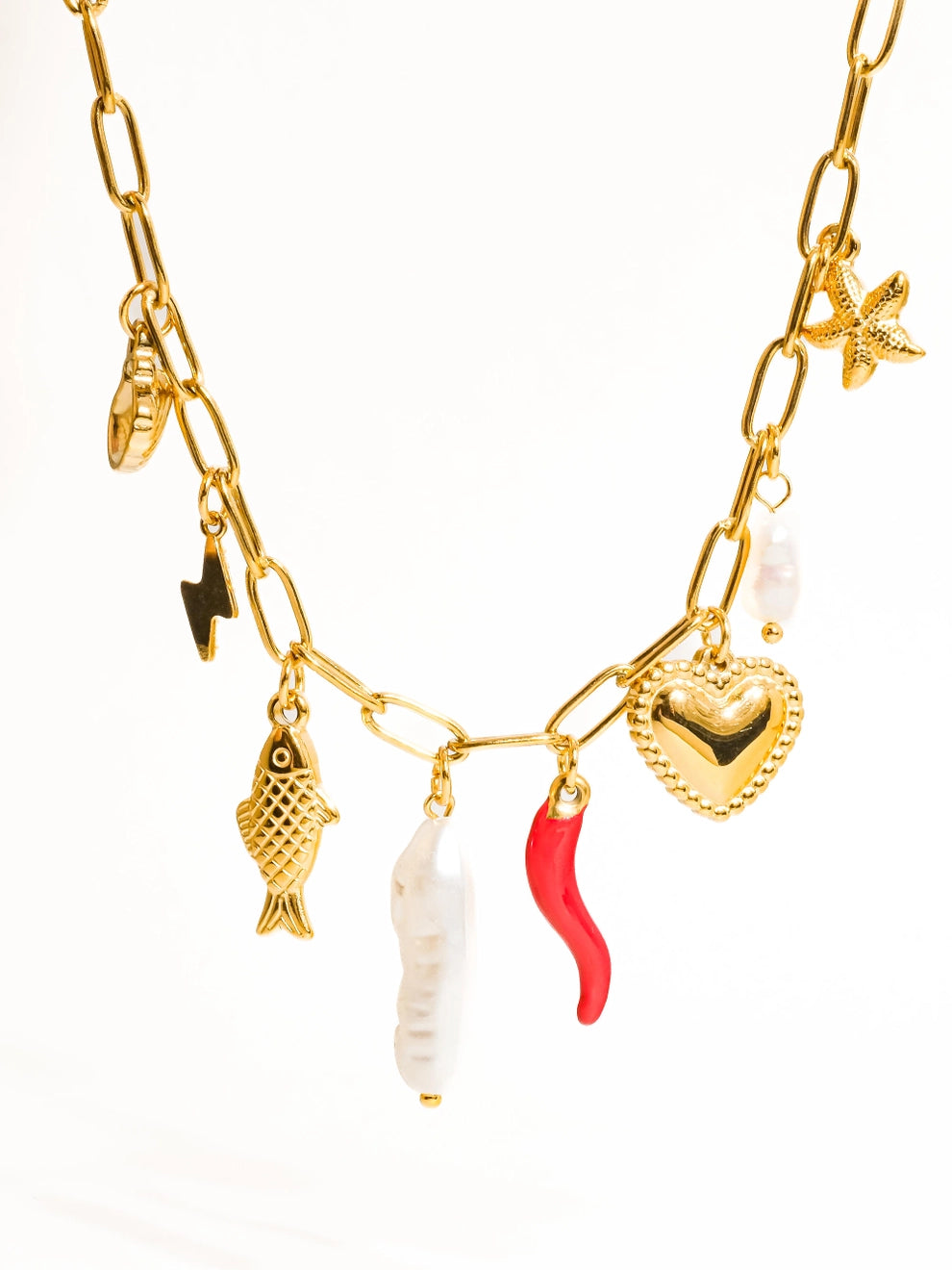 A gold-plated necklace with a variety of charms including a fish, a heart, and a star.