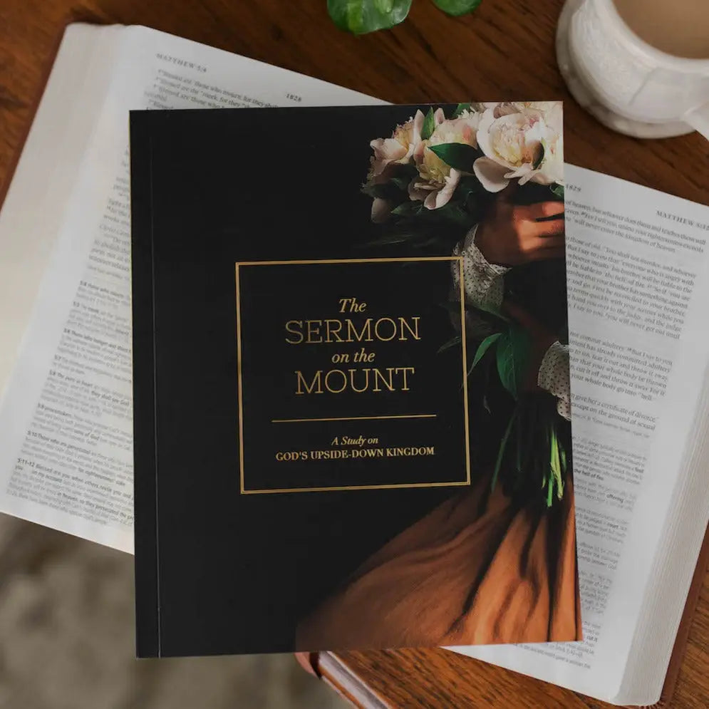 Book titled 'The Sermon on the Mount' on an open book with a cup of coffee in the background.