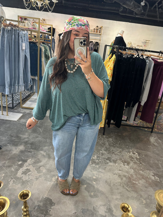 Woman in green and white striped shirt and jeans